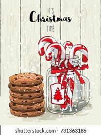 Christmas theme, candy canes in glass jar with red ribbon and stack of cookies, with text It's Christmas time on white wooden background, vector illustration, eps 10 with transparency