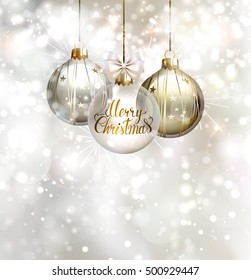 Christmas three evening balls. Merry Christmas gold lettering on the glass evening ball. Shining glimmered background.