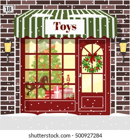 Christmas Toy shop toy store facade. Brown bricks. Decorated and illuminated cozy showcase with gift boxes, toys, Nutcracker, rocking-horse wreath, balls, xmas tree, snowflakes. Vector illustration