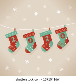 Christmas traditional socks with 2020 numbers and falling snowflakes background. Concept: New Year Eve and Christmas celebrations symbols etc.