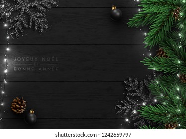 Christmas tree background. Xmas decoration design, bauble ball, snowflake color black, white light garland, pine cone, fir branches.  Flat lay,  French text Joyeux Noel, Bonne année.