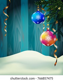 Christmas tree balls surrounded by gentle snowflakes on a wooden background
