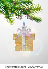 Christmas tree branch with gift box of wood. Wooden plank gift hanging on pine twig