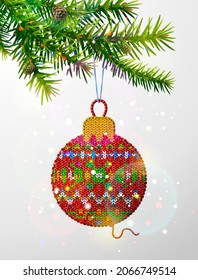 Christmas tree branch with knitted ornament. Crocheted christmas tree bauble hanging on pine twig