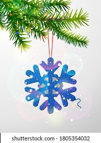 Christmas tree branch with knitted snowflake symbol. Crocheted snow sign hanging on pine twig