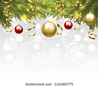 Christmas tree branches with baubles and golden serpentine streamers