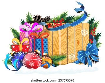 Christmas tree branches, gift boxes and baubles on wooden board with blue bow and ribbons