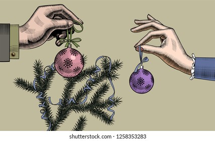Christmas tree cards. Woman's and man's hands with Christmas tree balls on a spruce branch with a red ribbon. Vintage engraving stylized drawing. Vector illustration