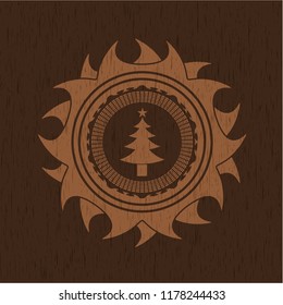 christmas tree icon inside badge with wood background