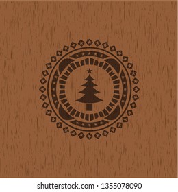 christmas tree icon inside badge with wooden background