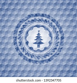 christmas tree icon inside blue emblem or badge with abstract geometric pattern background.