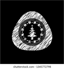 christmas tree icon inside chalkboard emblem on black board