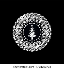 christmas tree icon inside chalkboard emblem on black board