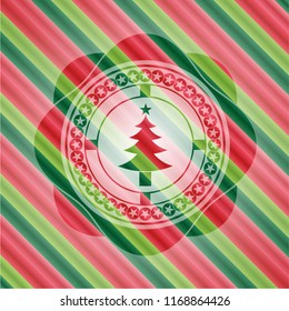 christmas tree icon inside christmas colors badge.