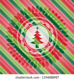 christmas tree icon inside christmas colors emblem.