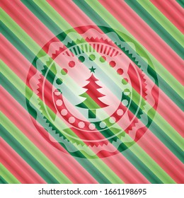 christmas tree icon inside christmas colors badge.