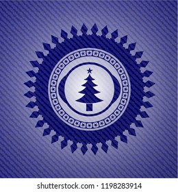 christmas tree icon inside emblem with jean background