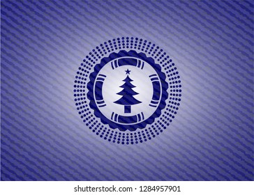 christmas tree icon inside emblem with denim high quality background