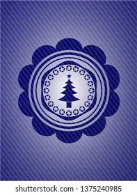 christmas tree icon inside emblem with jean background