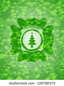 christmas tree icon inside green emblem with mosaic background