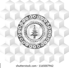 christmas tree icon inside grey badge with geometric cube white background