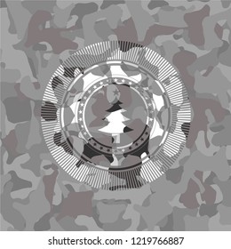 christmas tree icon inside grey camouflage emblem