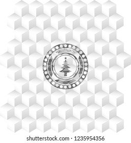 christmas tree icon inside grey badge with geometric cube white background