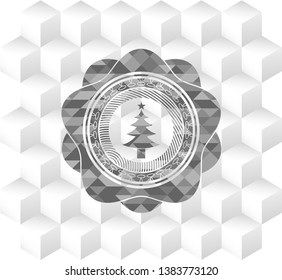 christmas tree icon inside grey emblem with geometric cube white background