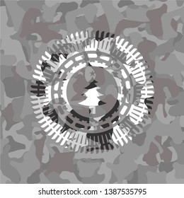 christmas tree icon inside grey camouflage emblem
