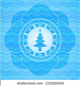christmas tree icon inside light blue water style badge.