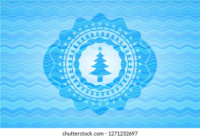 christmas tree icon inside light blue water badge background.