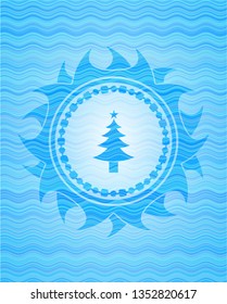 christmas tree icon inside light blue water style badge.