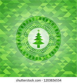 christmas tree icon inside realistic green emblem. Mosaic background