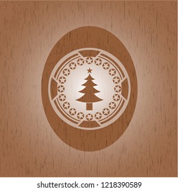 christmas tree icon inside realistic wooden emblem