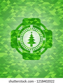 christmas tree icon inside realistic green emblem. Mosaic background
