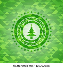 christmas tree icon inside realistic green emblem. Mosaic background