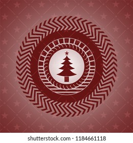 christmas tree icon inside red emblem