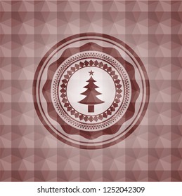 christmas tree icon inside red seamless badge with geometric pattern background.