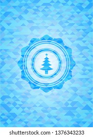 christmas tree icon inside sky blue mosaic emblem