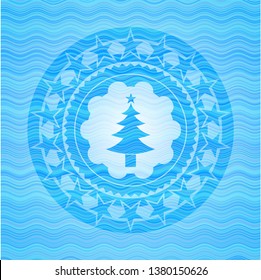 christmas tree icon inside sky blue water wave badge.