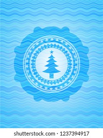 christmas tree icon inside water style badge.