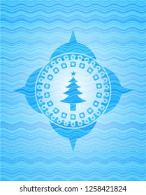 christmas tree icon inside water representation style emblem.