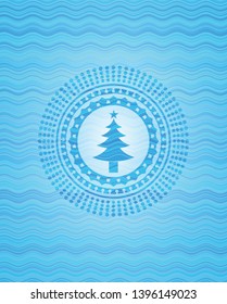 christmas tree icon inside water wave representation badge background.