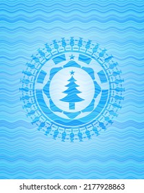 christmas tree icon inside water concept badge. 