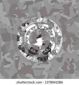 christmas tree icon on grey camouflaged texture