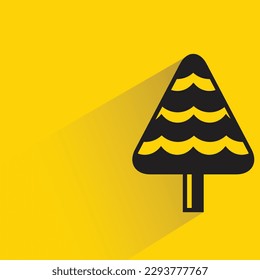 Christmas tree icon with shadow on yellow background