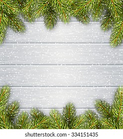 Christmas Tree Pine Branches Like Frame in Snowfall on White Wooden Background