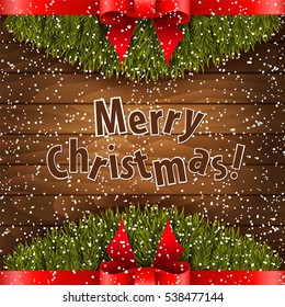 Christmas tree with red bow on the wood background.