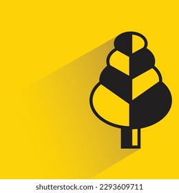 Christmas tree with shadow on yellow background