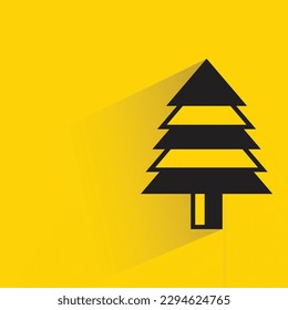 Christmas tree with shadow on yellow background